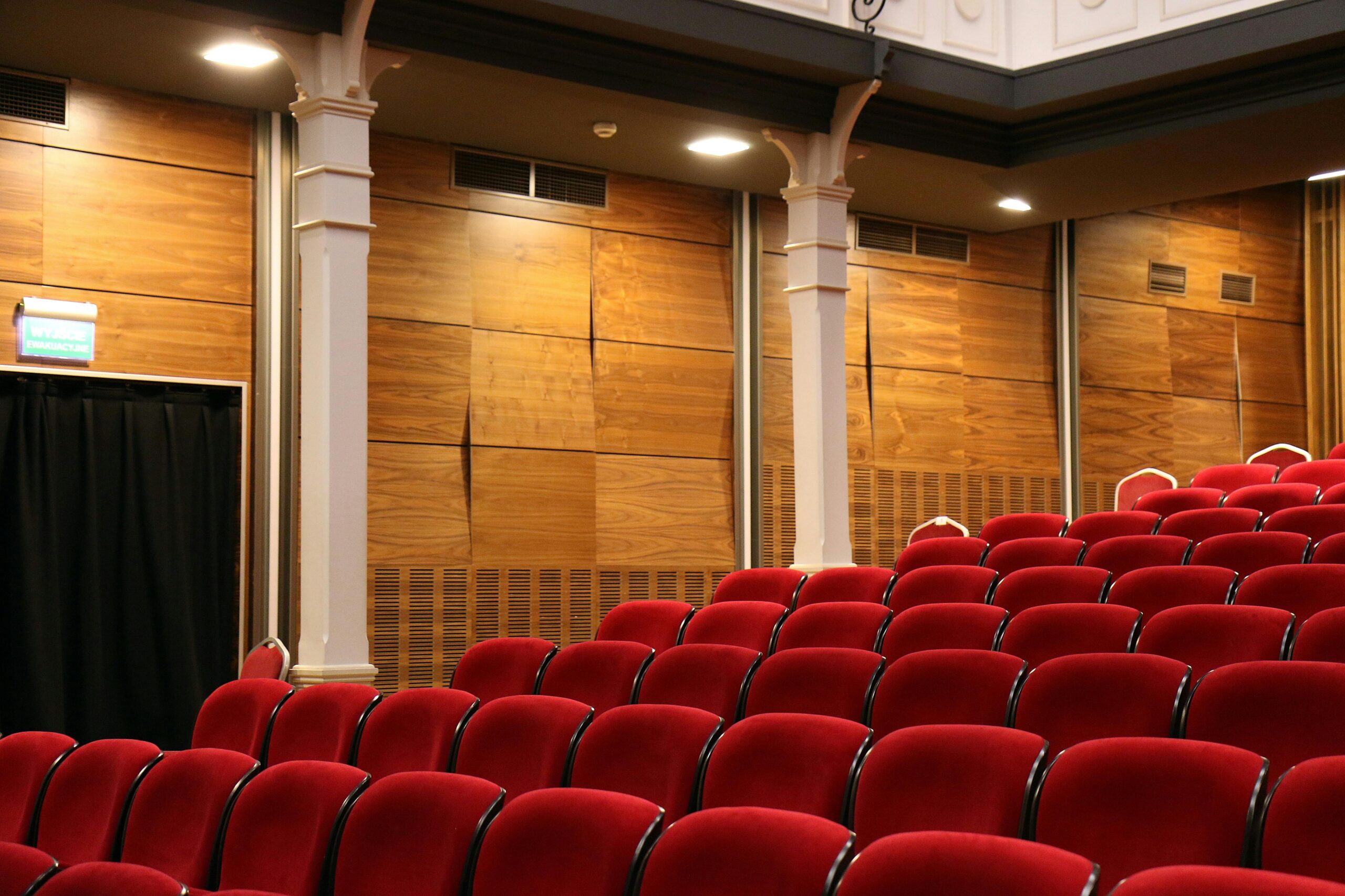 A row of vibrant red seats arranged neatly in a well-lit space, creating a striking visual contrast.